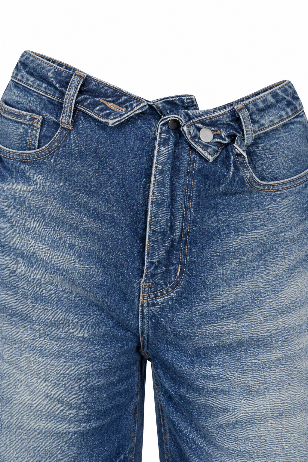 Jeans fold-over blu, dettaglio della vita incrociata con bottone scuro e linguetta chiara.