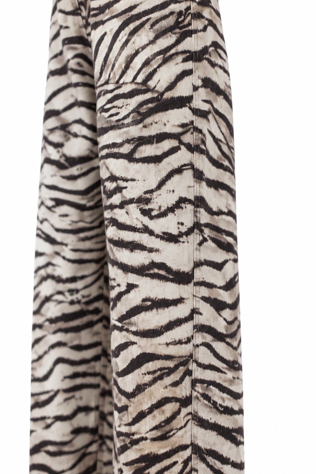Dettaglio laterale della gamba del pantalone zebra, su fondo bianco.
